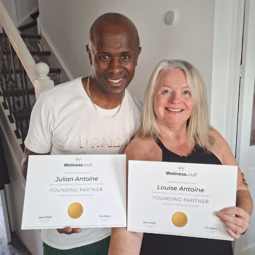 Louise and Julian Antoine holding Wellness.Club, Founding Partner Certificates and smiling happily. 